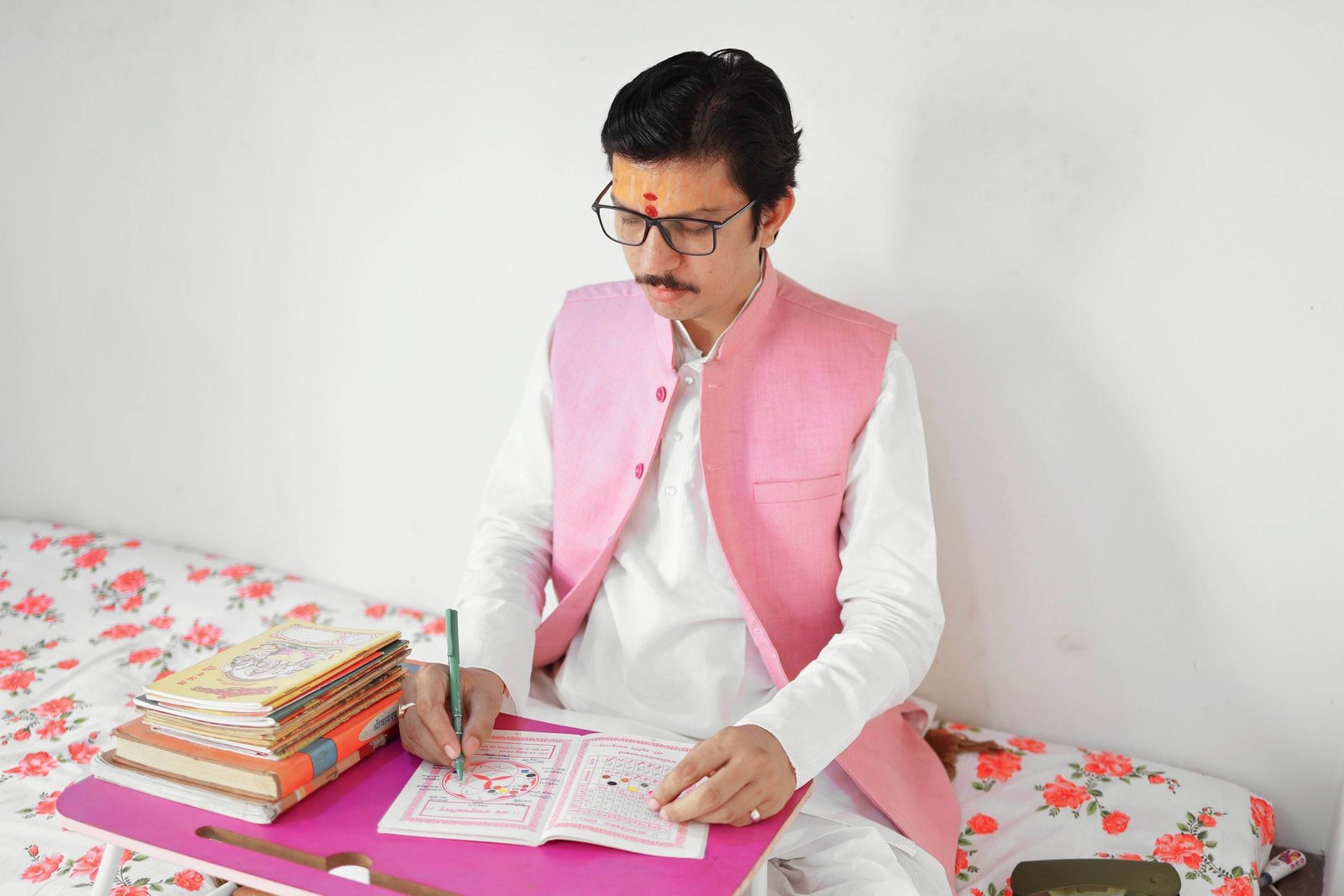 Acharya Neelesh Pandey Ji preparing a Kundli by hand